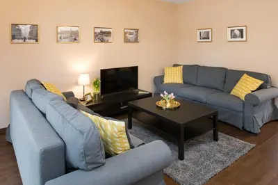 a living room with two couches and a coffee table at Krakow Central Apartment Free Parking in Kraków