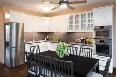 a kitchen with a black table and a refrigerator at Krakow Central Apartment Free Parking in Kraków
