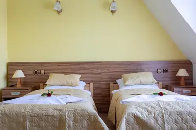 a bedroom with two beds with flowers on them at Hotel Góralski Raj in Nowy Targ