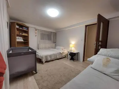 a bedroom with two beds and a desk in it at Studio in Kraków