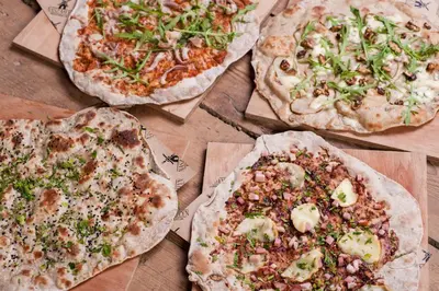 a group of pizzas sitting on top of a table at Nasz Młyn in Sufczyn