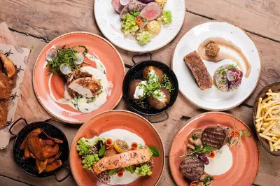 a group of plates of food on a wooden table at Nasz Młyn in Sufczyn