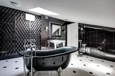 a black bathroom with a tub and a sink at Divon Luxury Apartments by Wawel Castle in Kraków