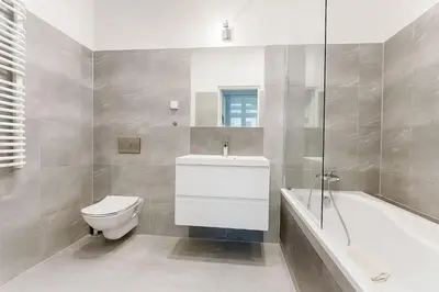 a bathroom with a toilet and a sink and a bath tub at Divon Luxury Apartments by Wawel Castle in Kraków