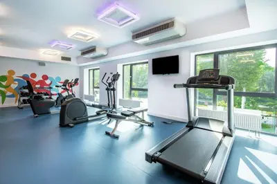 a gym with treadmills and elliptical machines at Hampton by Hilton Oswiecim in Oświęcim