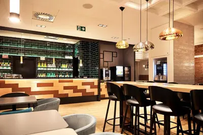 a conference room with a wooden table and chandeliers at B&B HOTEL Krakow Centrum in Kraków