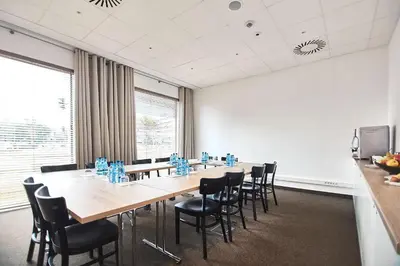a restaurant with tables and chairs in a room at B&B HOTEL Krakow Centrum in Kraków