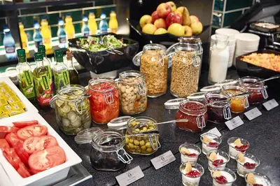 a buffet with different types of food on a table at B&B HOTEL Krakow Centrum in Kraków