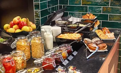 a buffet line with a lot of food on display at B&B HOTEL Krakow Centrum in Kraków