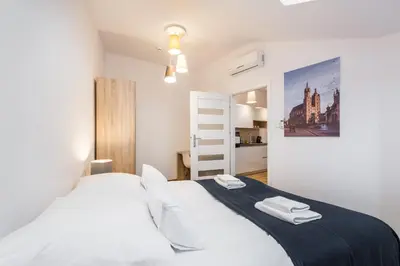 a bedroom with a bed with two towels on it at Apartamenty Bosacka WAWELOFTS in Kraków