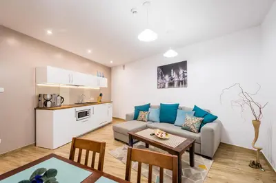 a living room with a couch and a table at Apartamenty Bosacka WAWELOFTS in Kraków