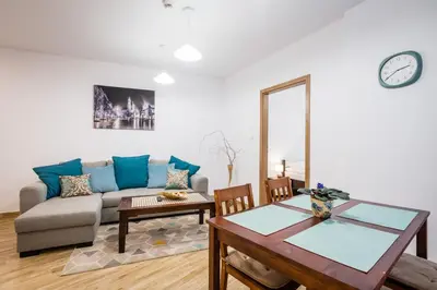 a living room with a couch and a table at Apartamenty Bosacka WAWELOFTS in Kraków