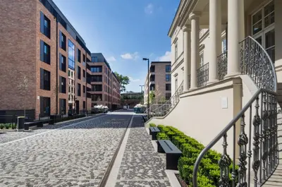 an empty street in a city with buildings at Browar Lubicz Residence in Kraków