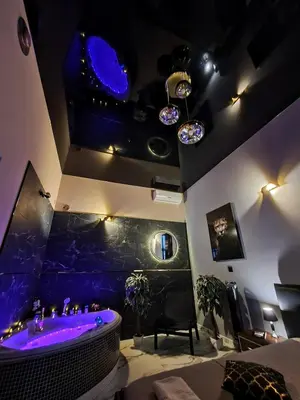 a room with a bath tub with purple lighting at Apartament z jacuzzi Kraków in Kraków