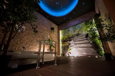 a room with a wall with a painting of a stairway at Apartament z jacuzzi Kraków in Kraków