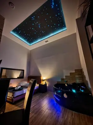 a room with a bed and a bathtub in a room at Apartament z jacuzzi Kraków in Kraków