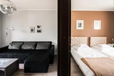 a living room with a couch and a bed at Apartamenty Algador in Kraków