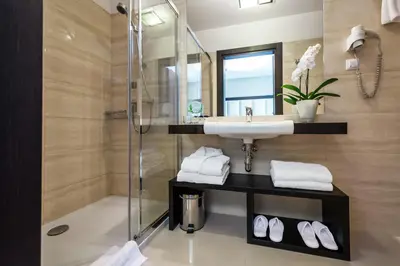 a bathroom with a sink and a shower at Queen Boutique Hotel in Kraków