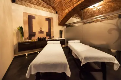 a room with three beds and a sink at Queen Boutique Hotel in Kraków