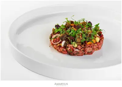 a plate of food on a white plate at Queen Boutique Hotel in Kraków
