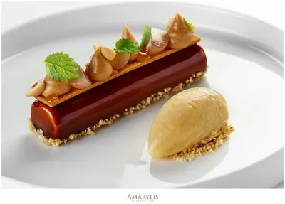 a piece of dessert on a white plate with a piece of ice cream at Queen Boutique Hotel in Kraków