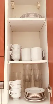 a cabinet filled with plates and cups and dishes at Zamoyskiego in Kraków