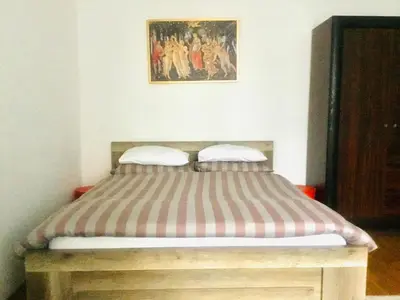 a bed with two pillows on it in a room at Zamoyskiego in Kraków