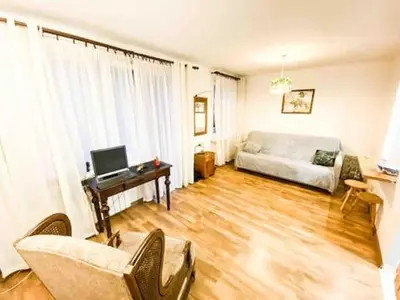 a living room with a couch and a desk at Comfortable Apartment in Kraków