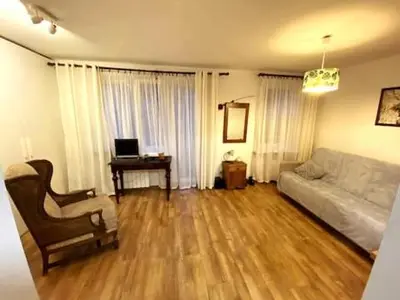 a living room with a couch and a table with a laptop at Comfortable Apartment in Kraków