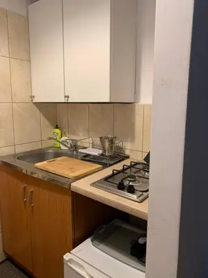 a kitchen with a sink and a stove top oven at Apartament Aga1 in Oświęcim