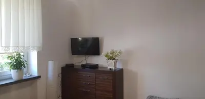 a tv sitting on top of a dresser in a room at Apartament Aga1 in Oświęcim