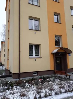 a building with a bench in front of it at Apartament Aga1 in Oświęcim