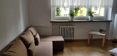 a living room with a couch and a window at Apartament Aga1 in Oświęcim