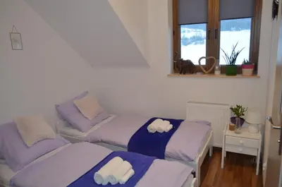 a living room with two beds and a couch at Pokoje na Wzgórzu in Kasina Wielka