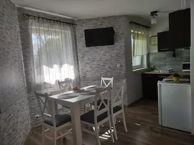 a kitchen and dining room with a table and chairs at Idylla in Połom Mały