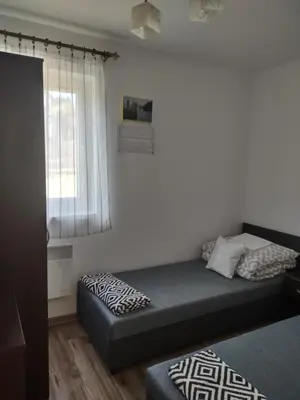 a small bedroom with a bed and a window at Idylla in Połom Mały