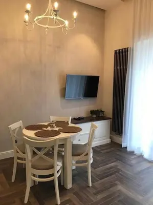 a dining room with a table and chairs and a television at Apartament w centrum Krakowa Ariańska 6 in Kraków