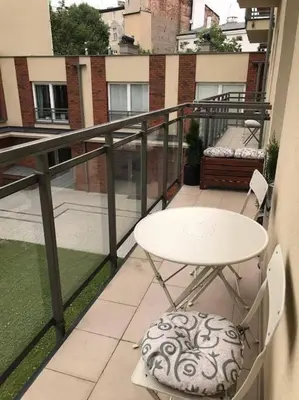 a balcony with a white table and chairs on a balcony at Apartament w centrum Krakowa Ariańska 6 in Kraków
