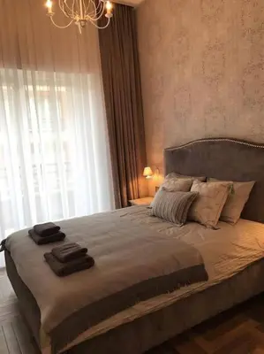 a bedroom with a large bed with two towels on it at Apartament w centrum Krakowa Ariańska 6 in Kraków