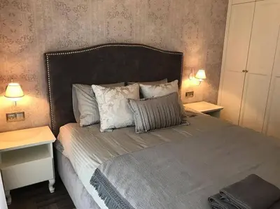 a bedroom with a bed with two tables and two lamps at Apartament w centrum Krakowa Ariańska 6 in Kraków