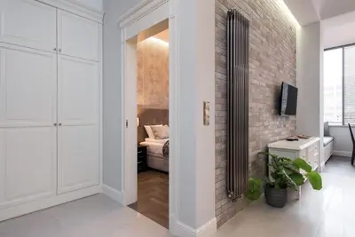 a room with a hallway with a brick wall at Apartament w centrum Krakowa Ariańska 4 in Kraków