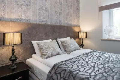 a bedroom with a large bed with two lamps at Apartament w centrum Krakowa Ariańska 4 in Kraków