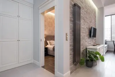 a room with a hallway with a brick wall at Apartament w centrum Krakowa Ariańska 4 in Kraków