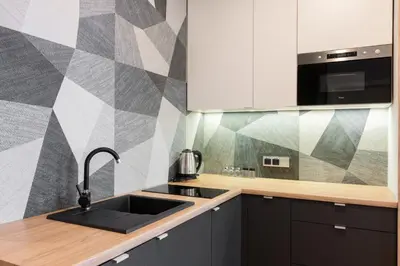 a kitchen with a sink and a geometric wall at Luxury Apartments Nearto Main Square in Kraków