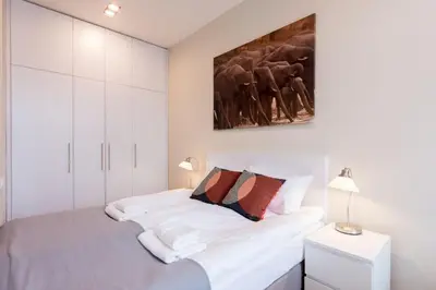 a white bedroom with a bed with white cabinets at Luxury Apartments Nearto Main Square in Kraków
