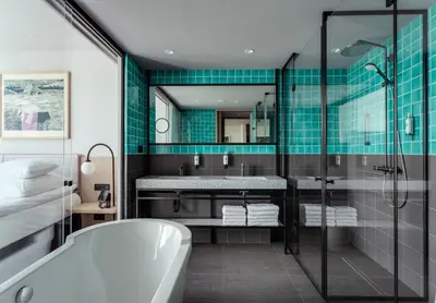 a bathroom with a bath tub and a sink at PURO Kraków Kazimierz in Kraków