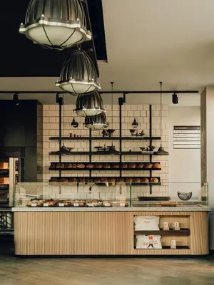 a bakery with a counter with pastries on it at PURO Kraków Kazimierz in Kraków