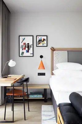 a bedroom with a bed and a desk and a bed and a chair at PURO Kraków Kazimierz in Kraków