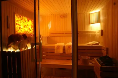 a sauna with two beds and towels in it at Hotel Krak in Myślenice