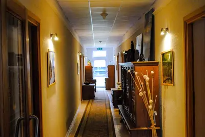 a hallway of a room with yellow walls and a hallwayngth at Hotel Krak in Myślenice